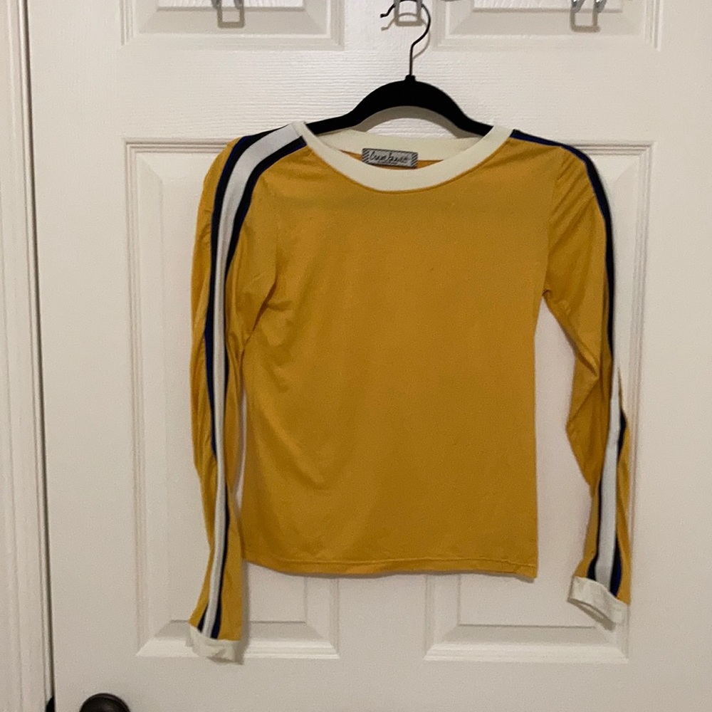 A mustard long sleeve with strips down the sides